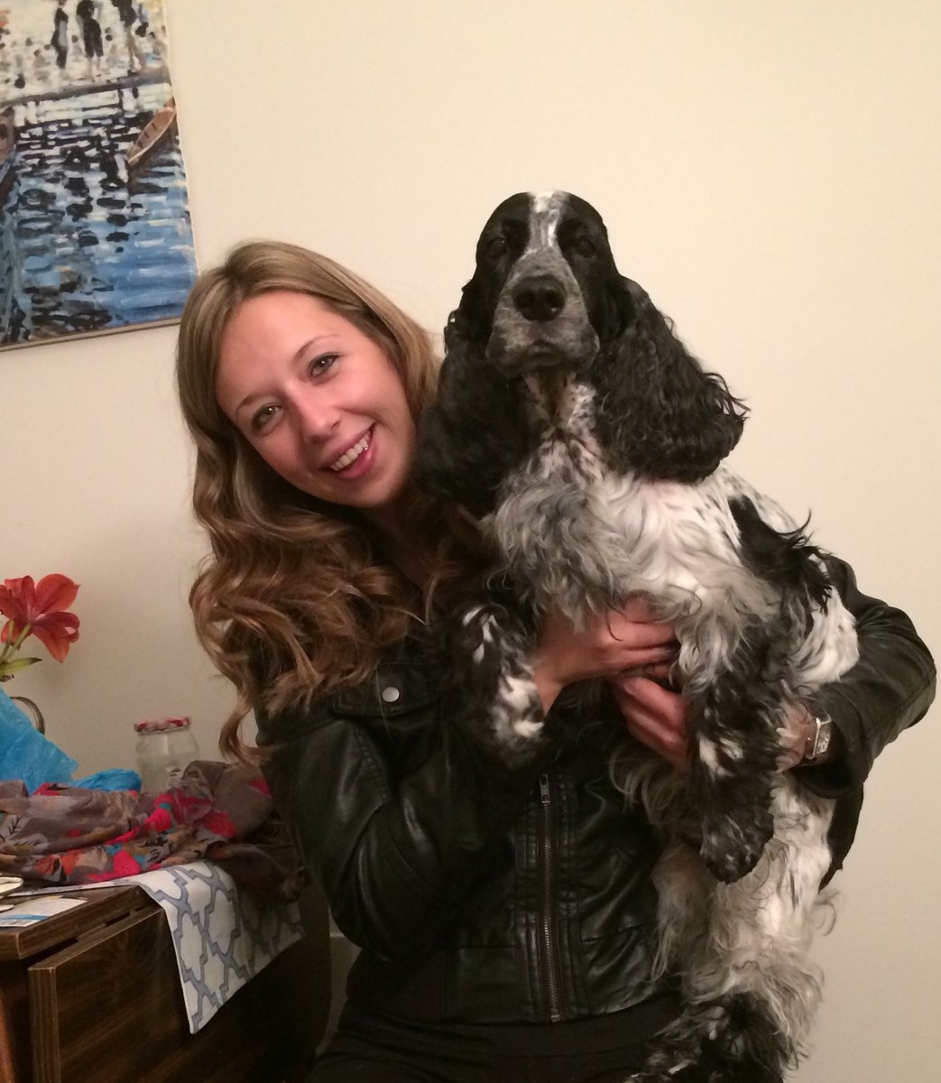 Natalie holding her English Cocker Spaniel