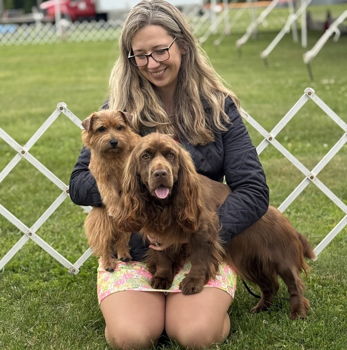 Natalie holding her Norfolk Terrier and Sussex Spaniel